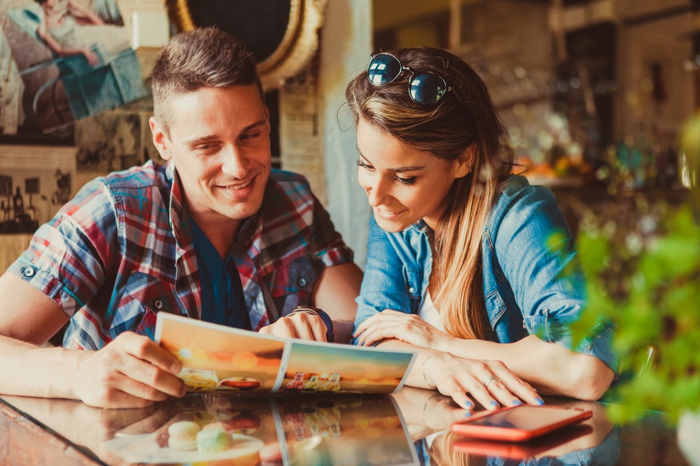 Restaurants in Okoboji, happy couple looking at a casual diner menu 