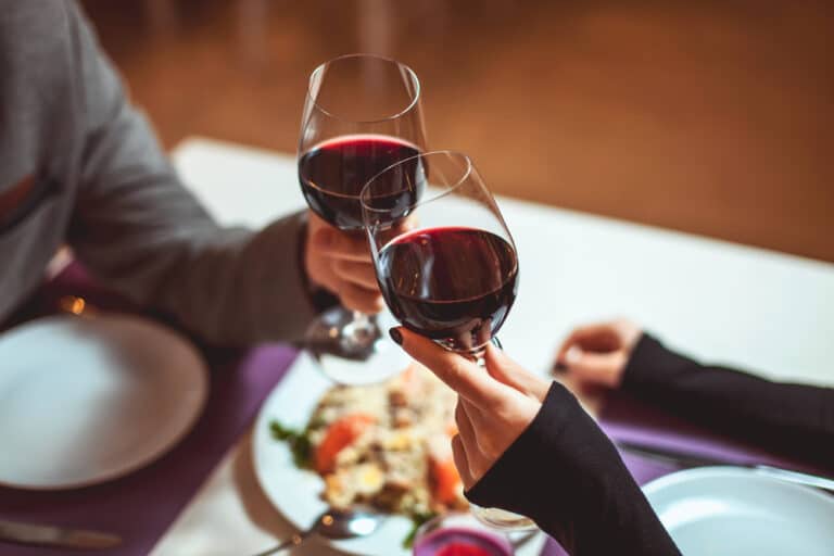 Restaurants in Okoboji, couple drinking red wine and enjoying a lovely meal at a restaurant