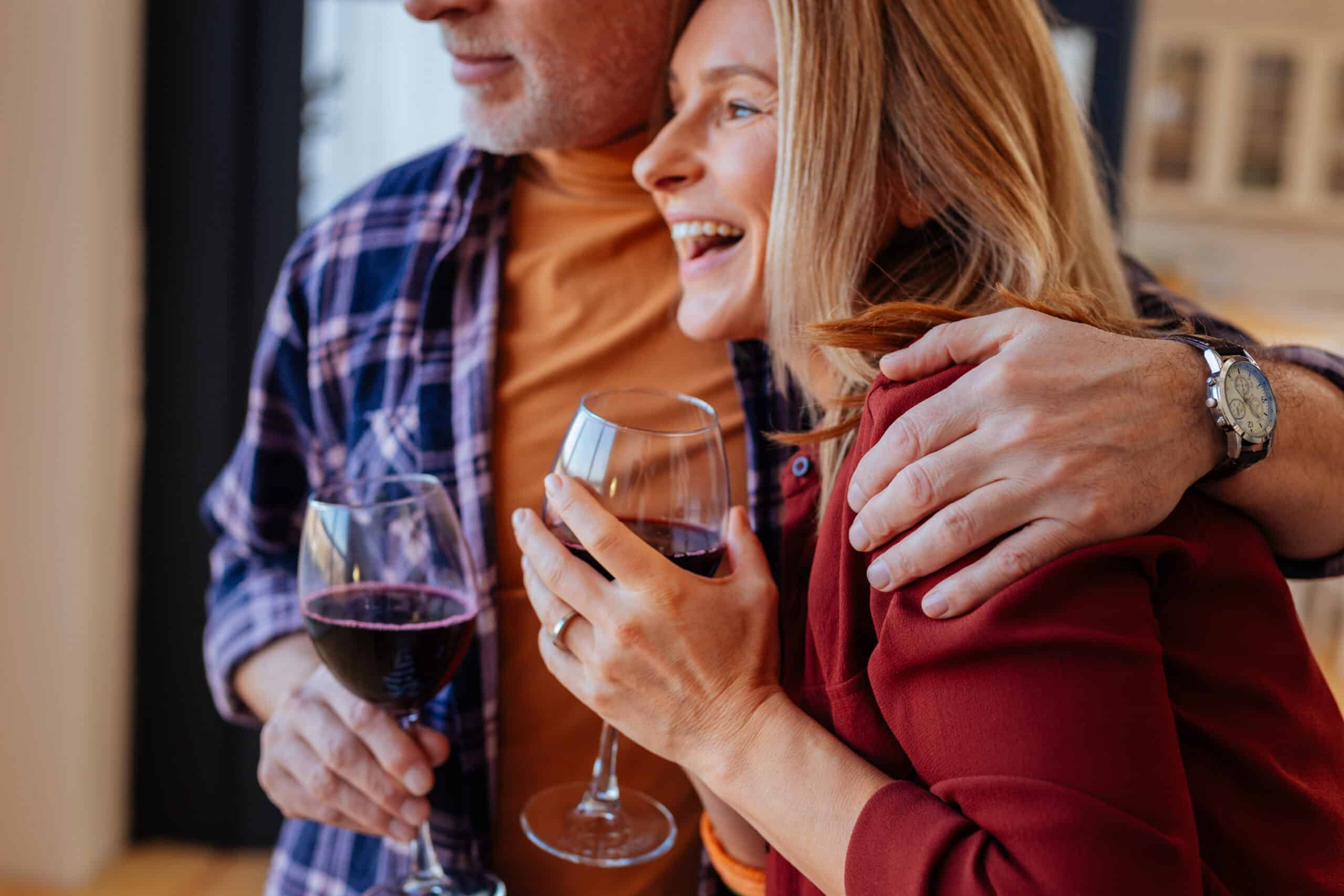 A happy man and woman enjoying a glass of wine on the Best Iowa Getaways for Couples